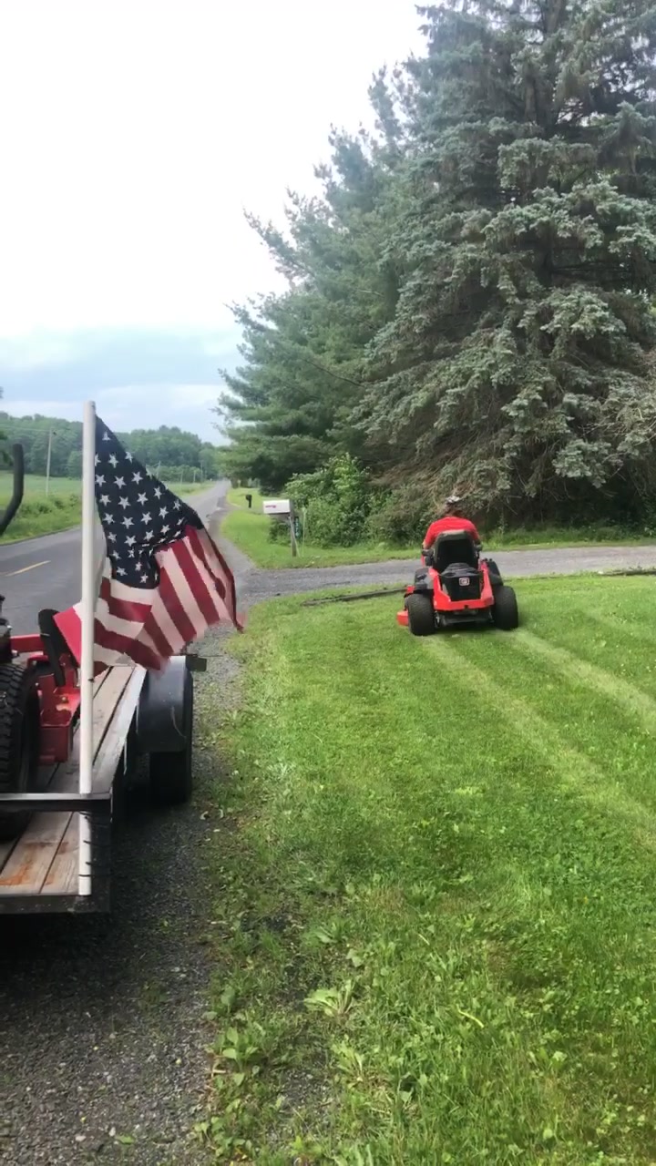 Crew equipment mowing a rural roadside property
